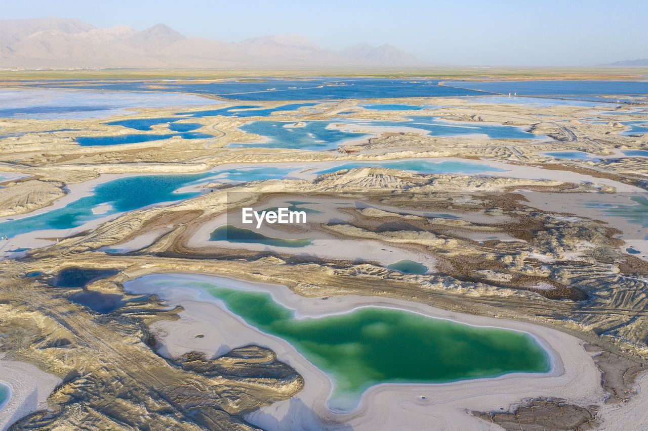 AERIAL VIEW OF RIVER PASSING THROUGH LANDSCAPE