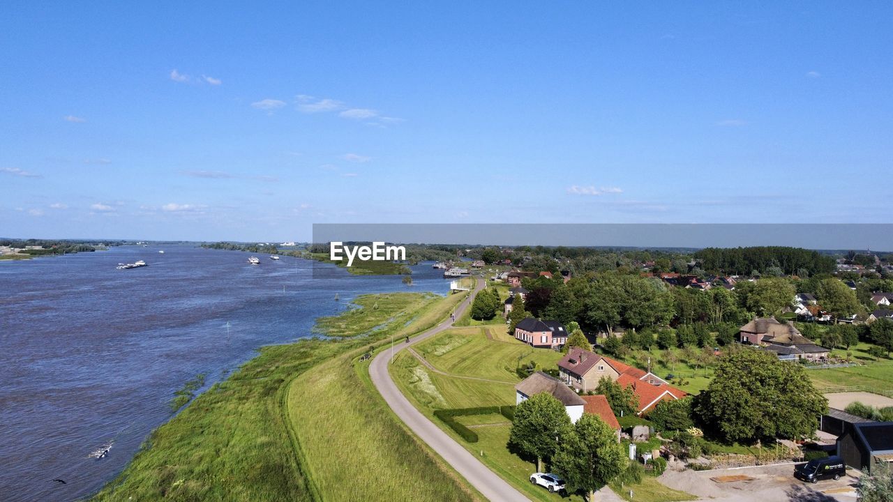 High angle view of townscape by sea against sky