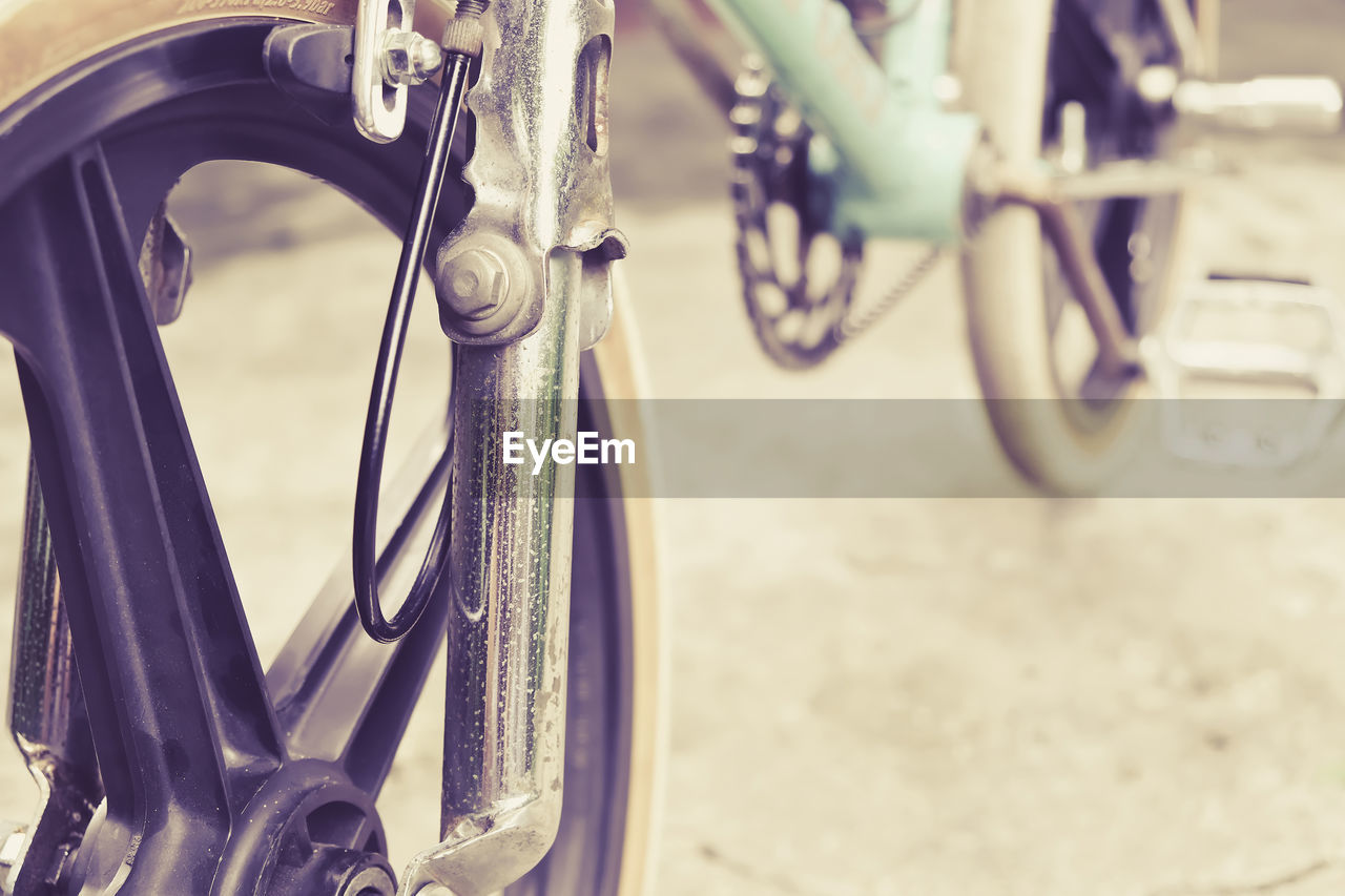 Close-up of bicycle wheel on road