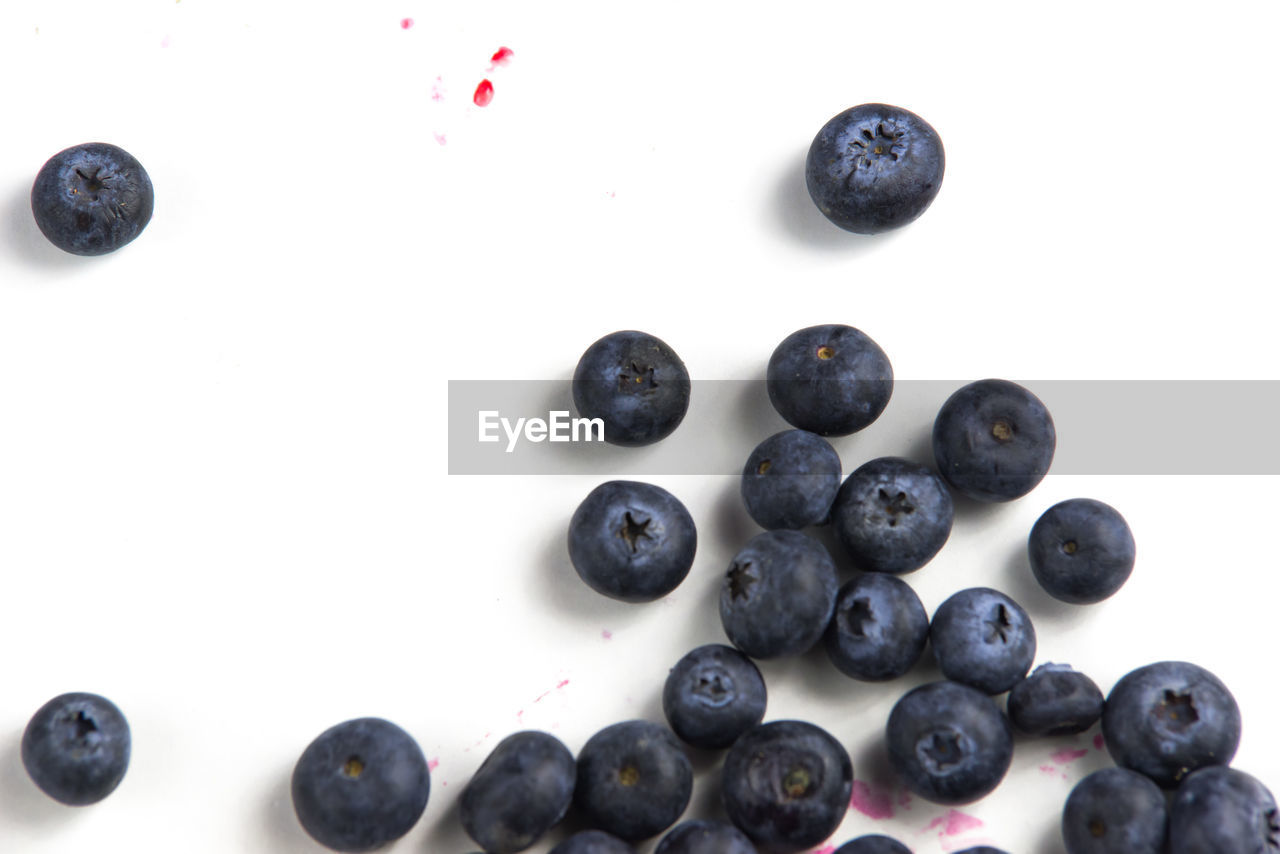 Close-up of blueberries over white background
