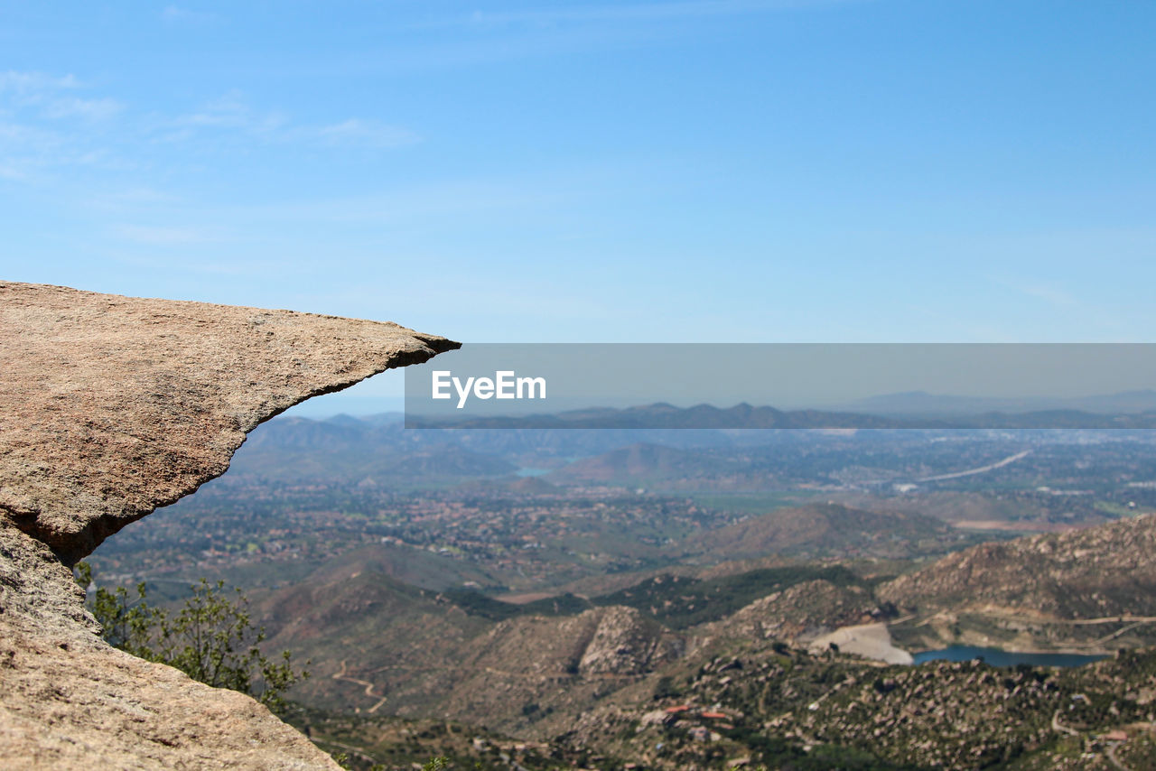 Potato chip rock - flat overhanging rock in front of a landscape