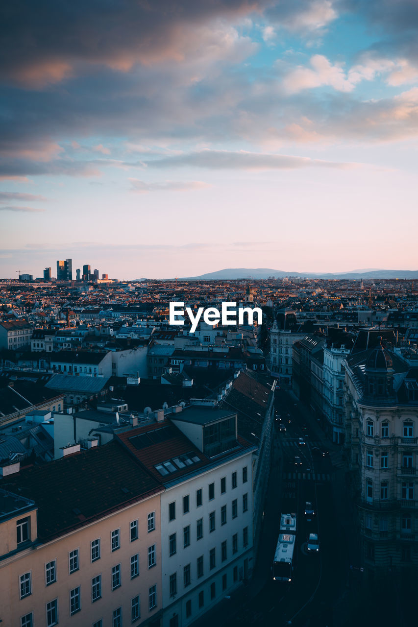 High angle view of cityscape against cloudy sky