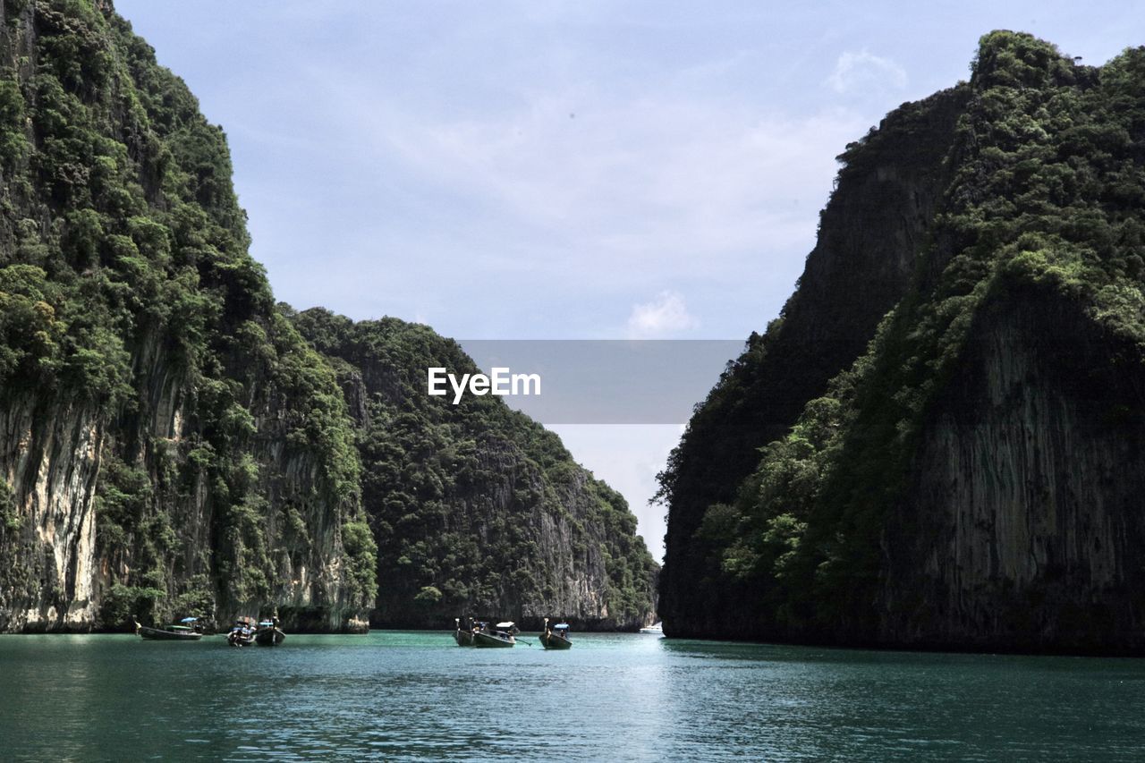 SCENIC VIEW OF ROCK FORMATION IN WATER AGAINST SKY