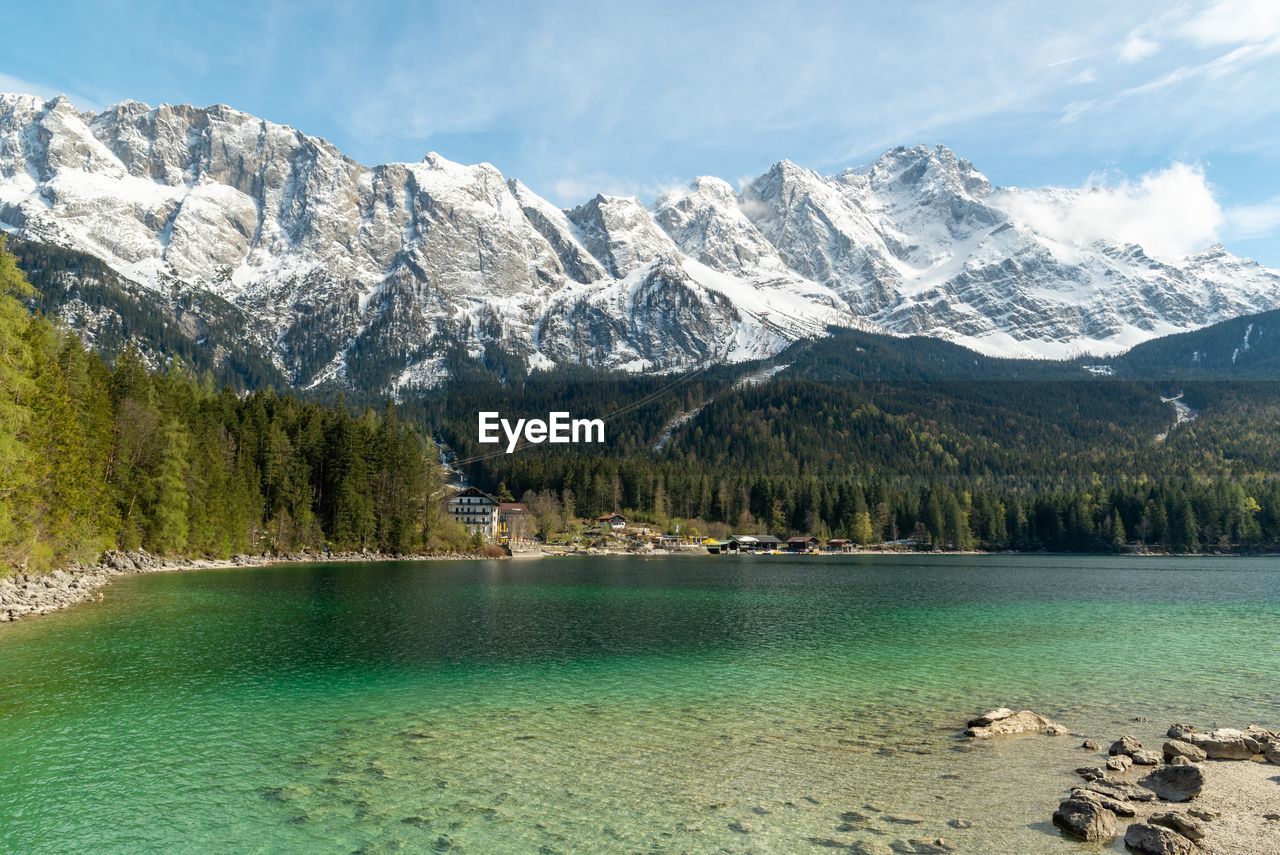 Scenic view of lake and snowcapped mountains against sky