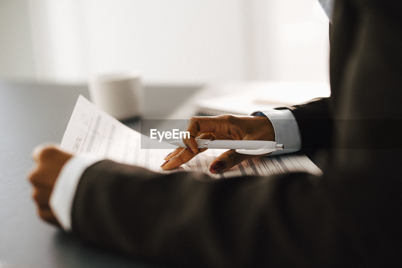 Woman's hands holding documents