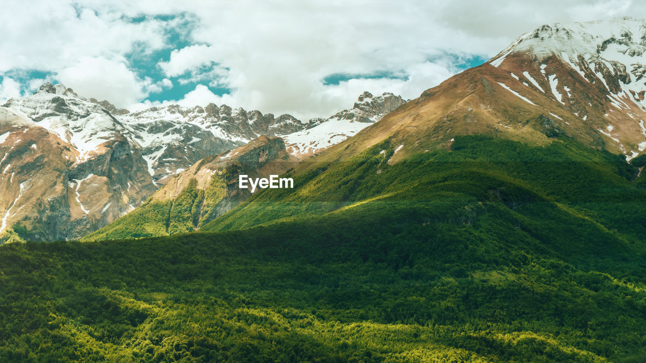 mountain, environment, landscape, nature, scenics - nature, mountain range, beauty in nature, cloud, land, sky, snow, cold temperature, plant, winter, travel, meadow, travel destinations, snowcapped mountain, mountain peak, green, highland, mountain pass, grass, valley, no people, tranquility, wilderness, tranquil scene, non-urban scene, ridge, tourism, plateau, outdoors, rural scene, forest, activity, environmental conservation, field, social issues, idyllic, tree, coniferous tree, plain, day, pinaceae, trip, vacation, summer, holiday, pine tree, leisure activity, fog, rock