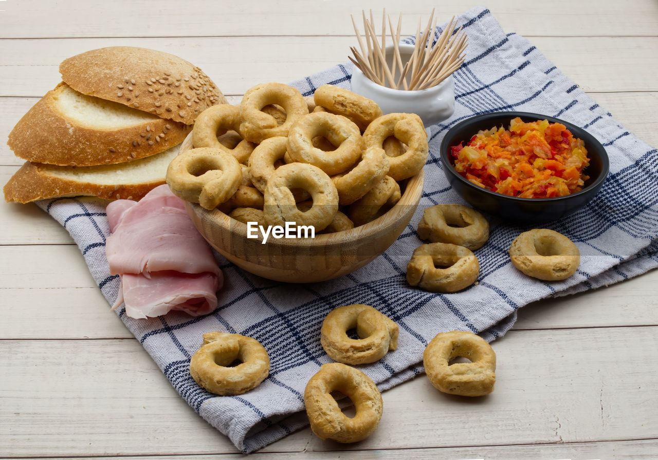 Taralli alla pugliese with extra virgin olive oil . traditional italian snack taralli