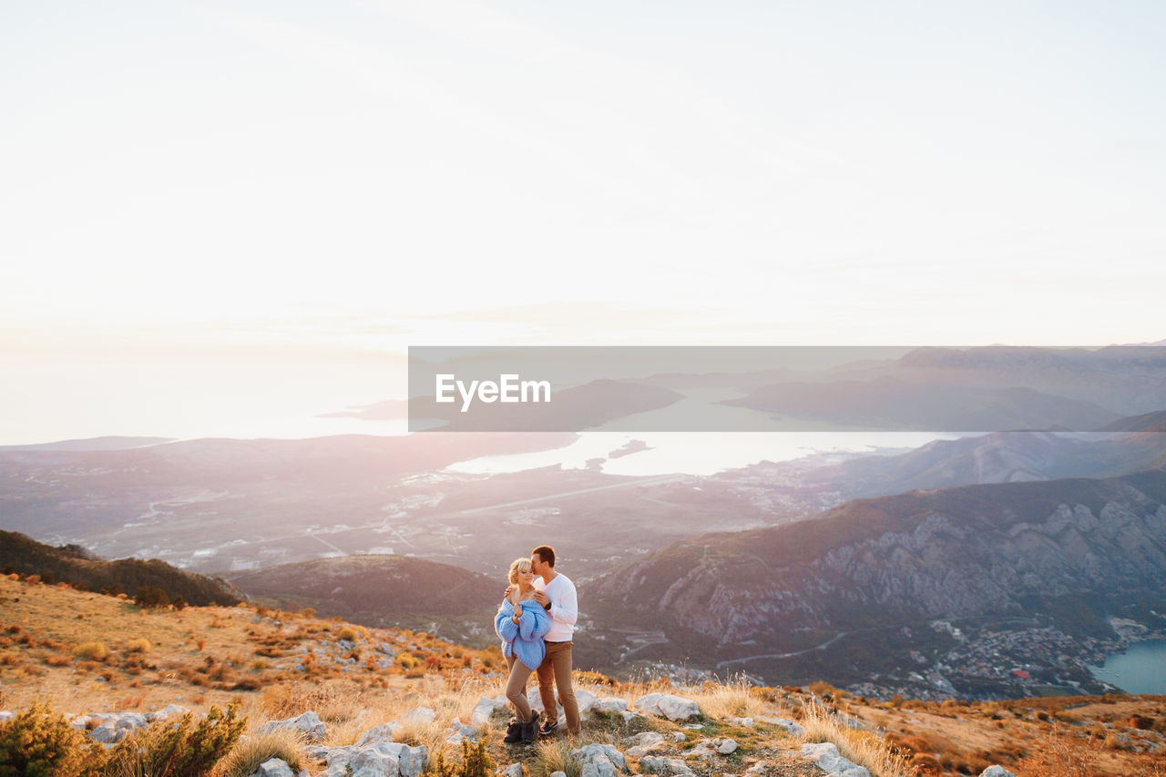 FULL LENGTH OF MAN STANDING ON MOUNTAIN