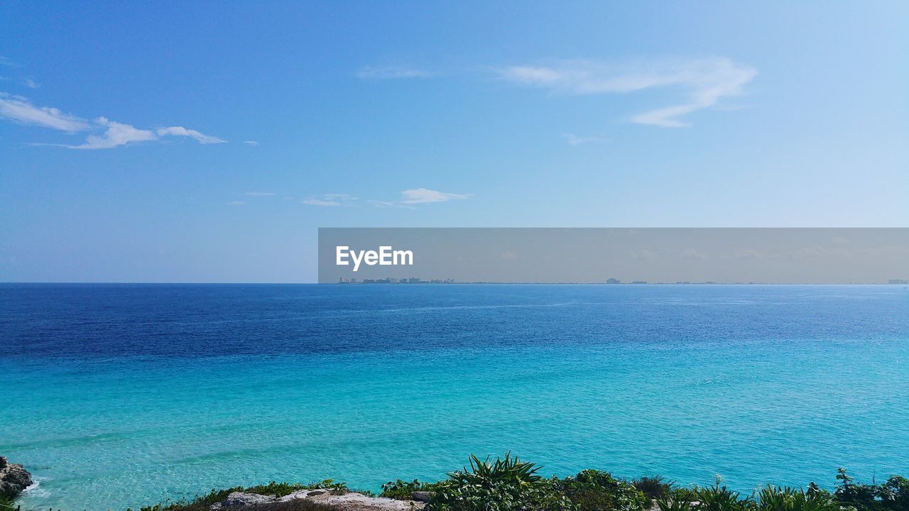 Scenic view of sea against blue sky