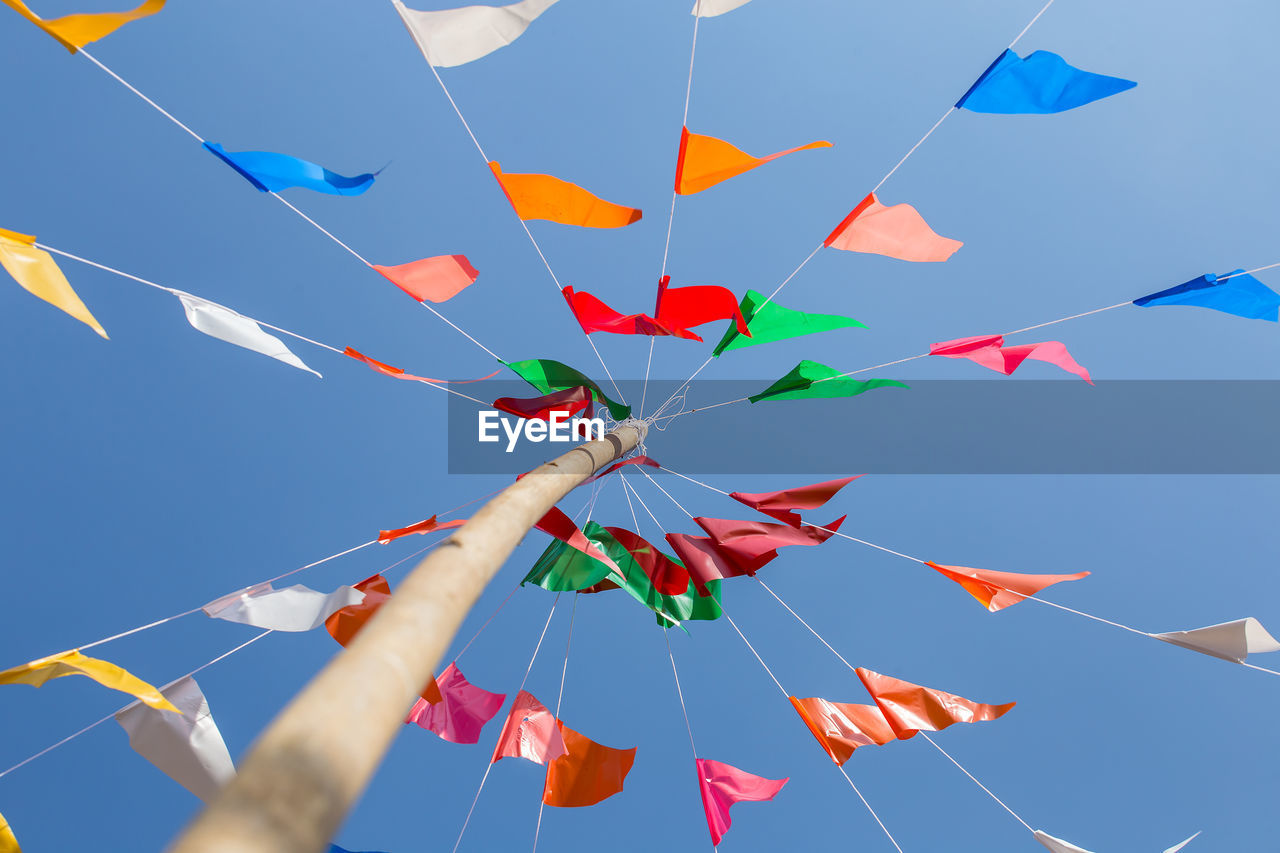 LOW ANGLE VIEW OF DECORATION HANGING AGAINST SKY