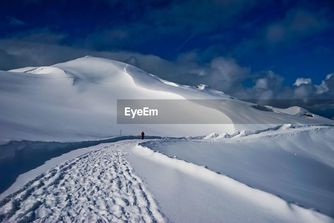 Scenic view of snowcapped mountains against sky