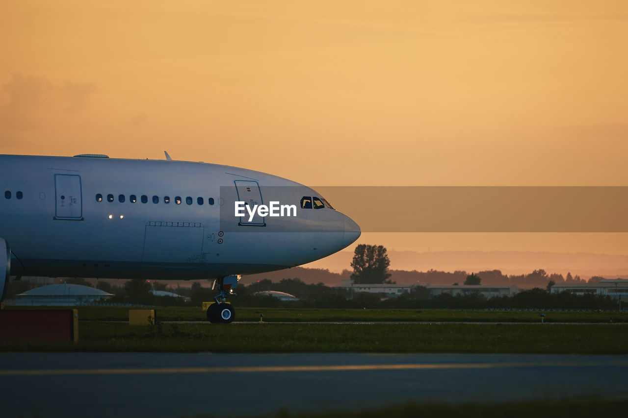 Airplane taxiing to runway for take off. airport at golden sunset.