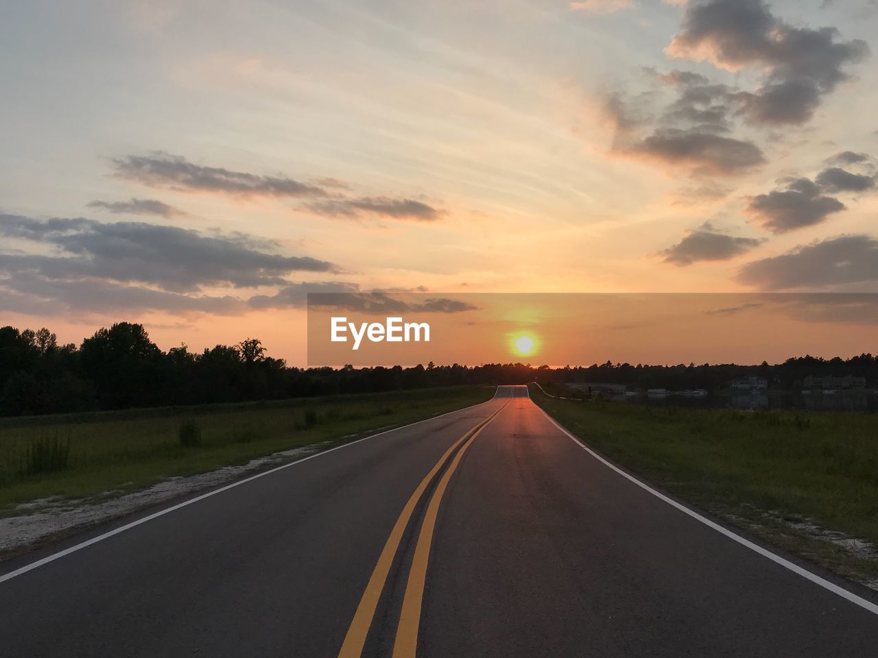 EMPTY ROAD AGAINST SKY DURING SUNSET