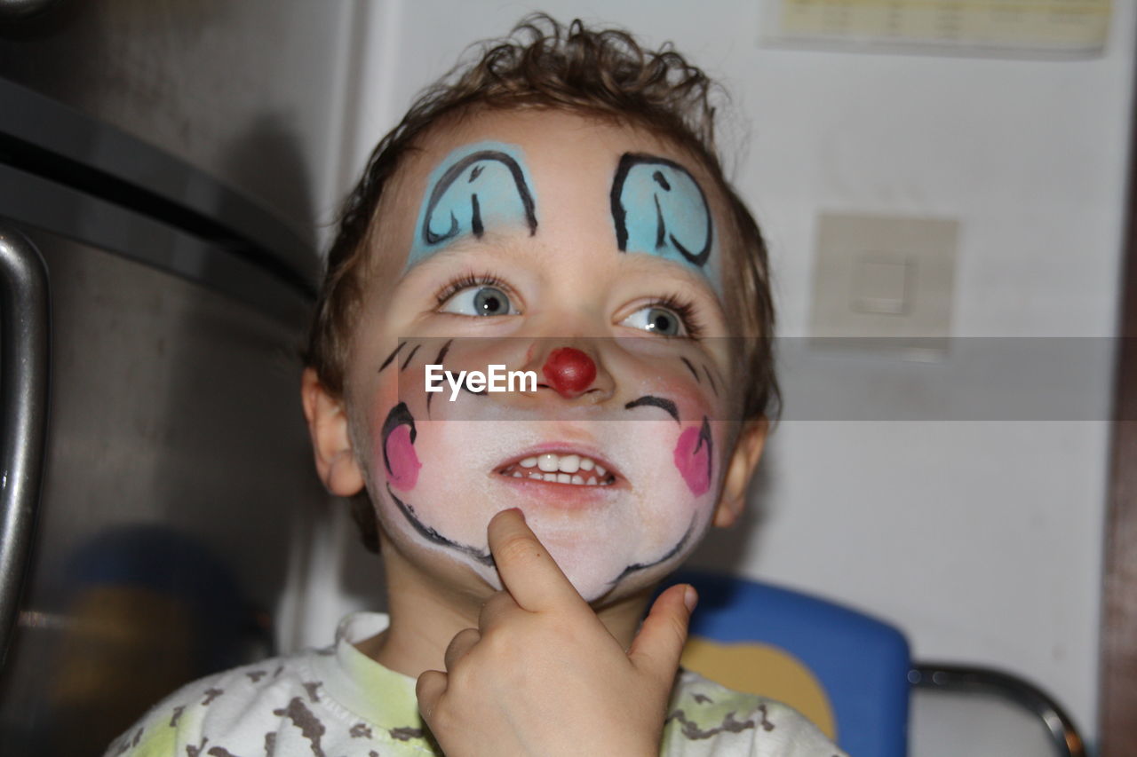 Portrait of young boy, carnival  clown