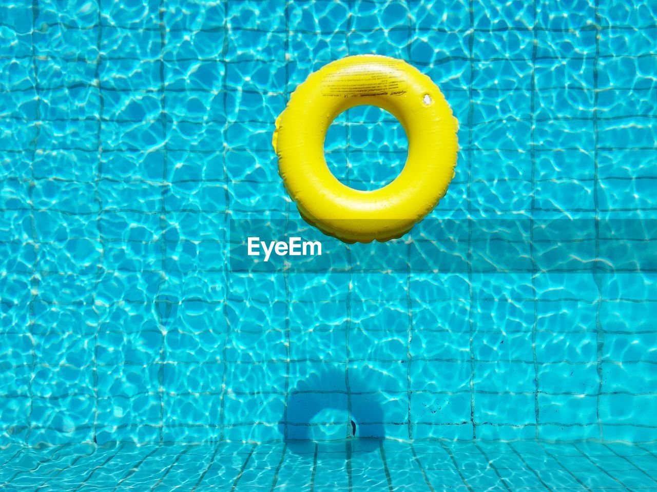 High angle view of yellow rubber ring in the pool