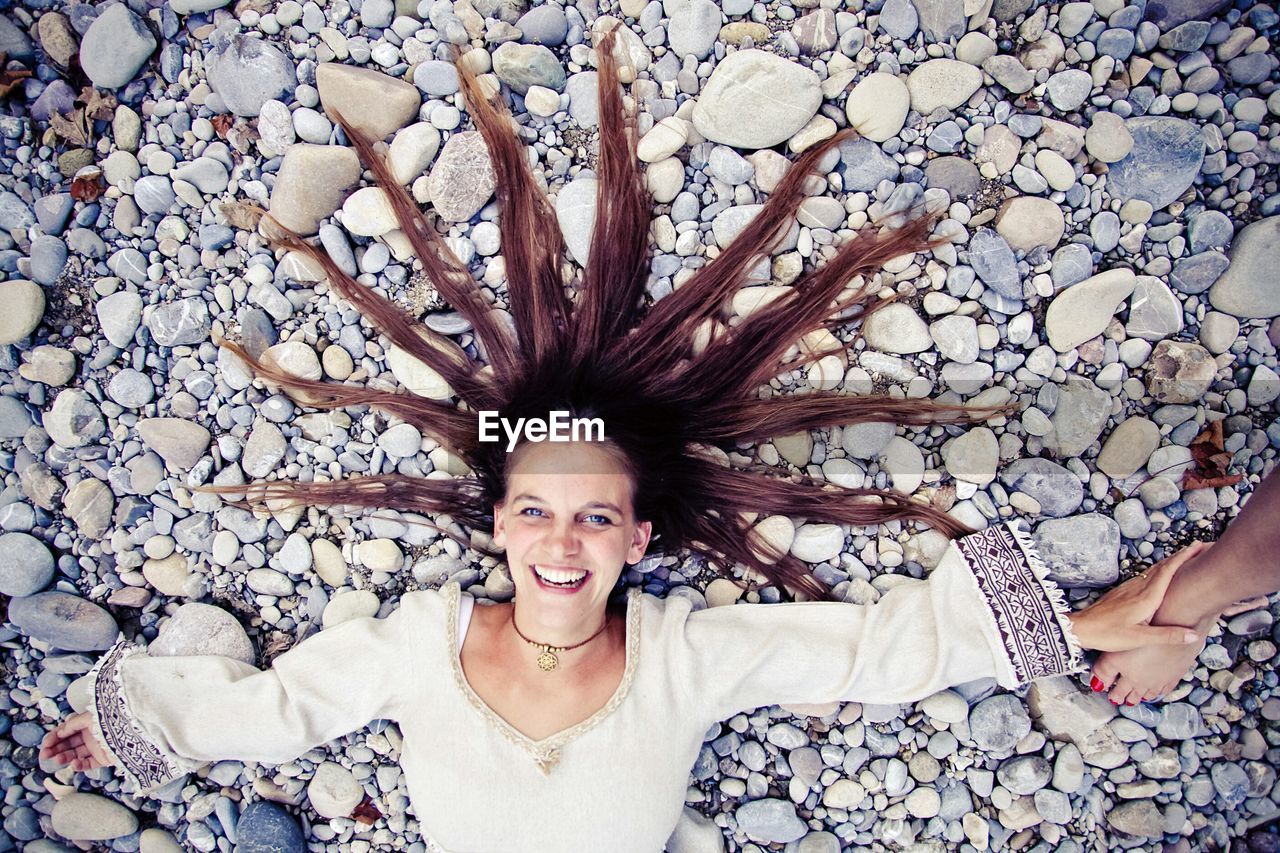 Portrait of young woman with hair arranged on ground