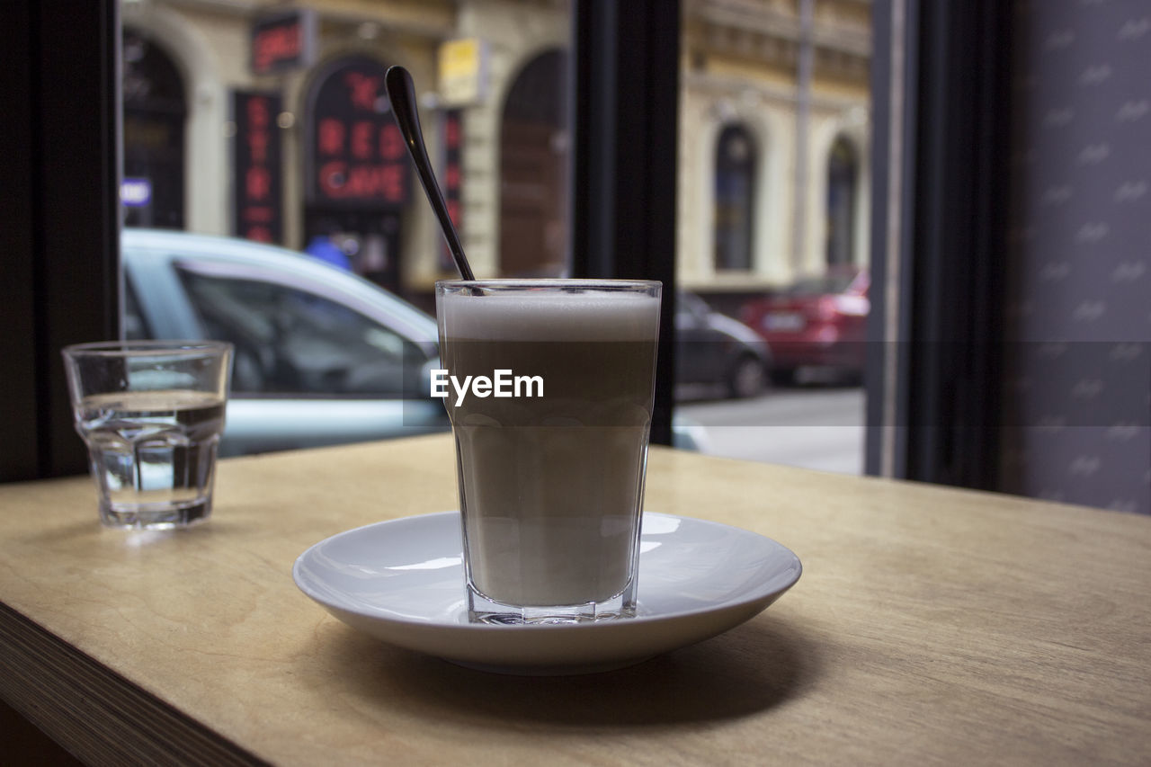 GLASS OF COFFEE ON TABLE