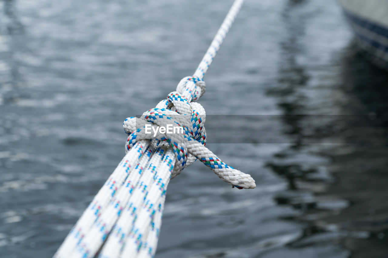 High angle view of ropes tied over sea