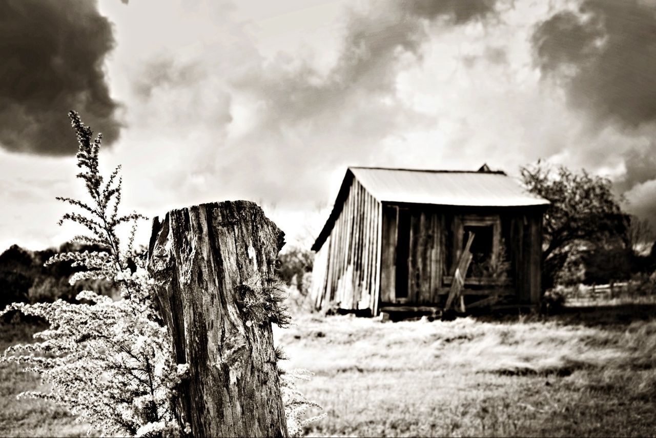 Old hut under cloudy sky