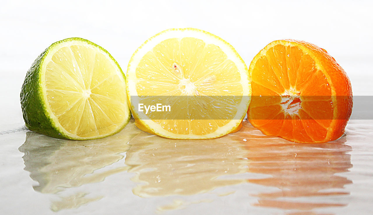 CLOSE-UP OF LEMON AGAINST WHITE BACKGROUND