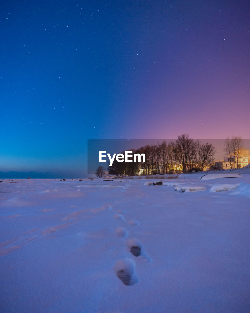 Scenic view of snow covered landscape against blue sky