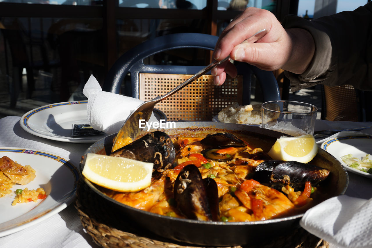 Close-up of person preparing food on table