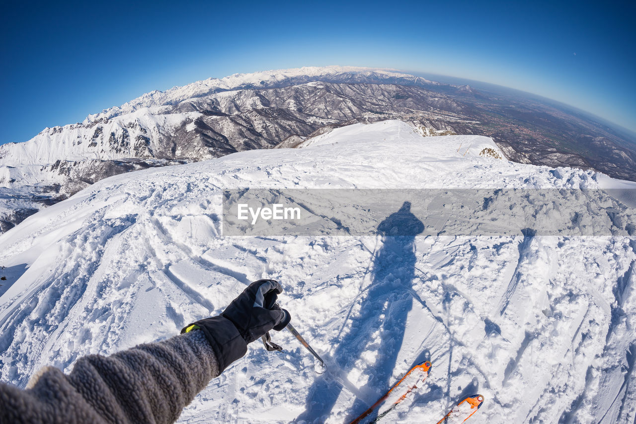 Cropped image of person skiing on snow covered mountain