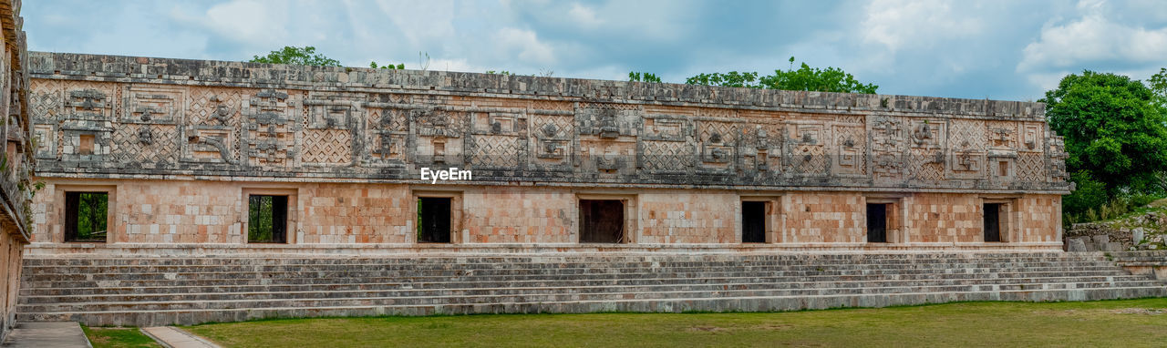 EXTERIOR OF OLD BUILDING AGAINST CLOUDY SKY