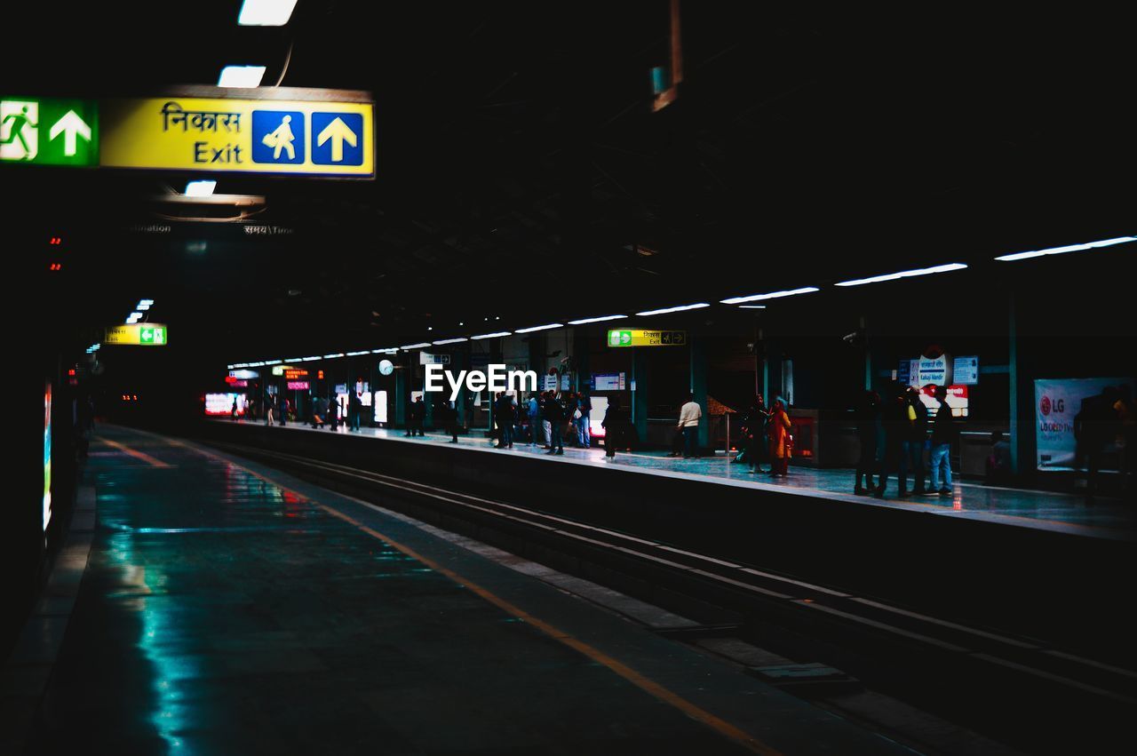 Illuminated railroad station platform at night