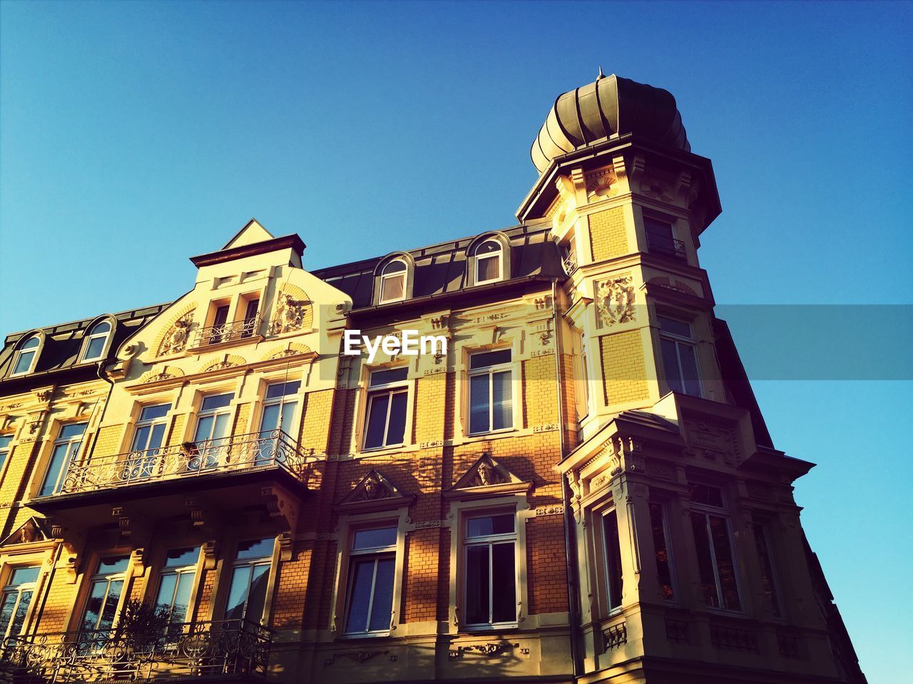 Low angle view of building against clear blue sky