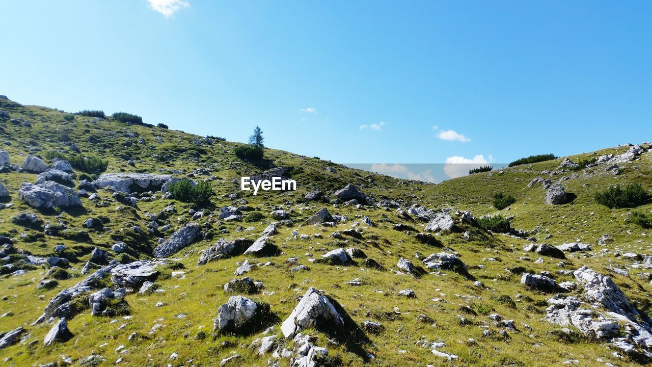 Low angle view of mountain range against cloudy sky