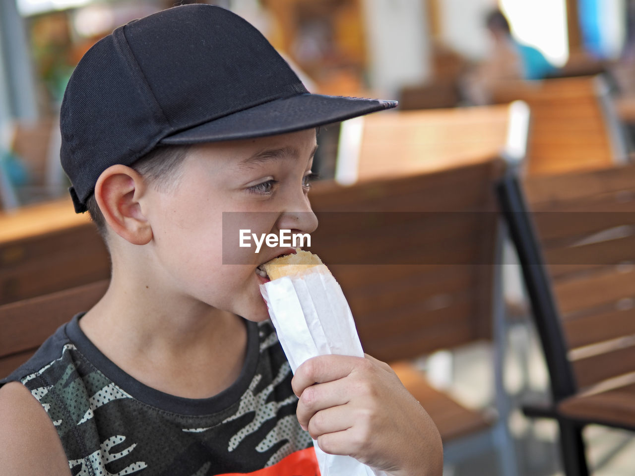 Cute boy eating food at cafe