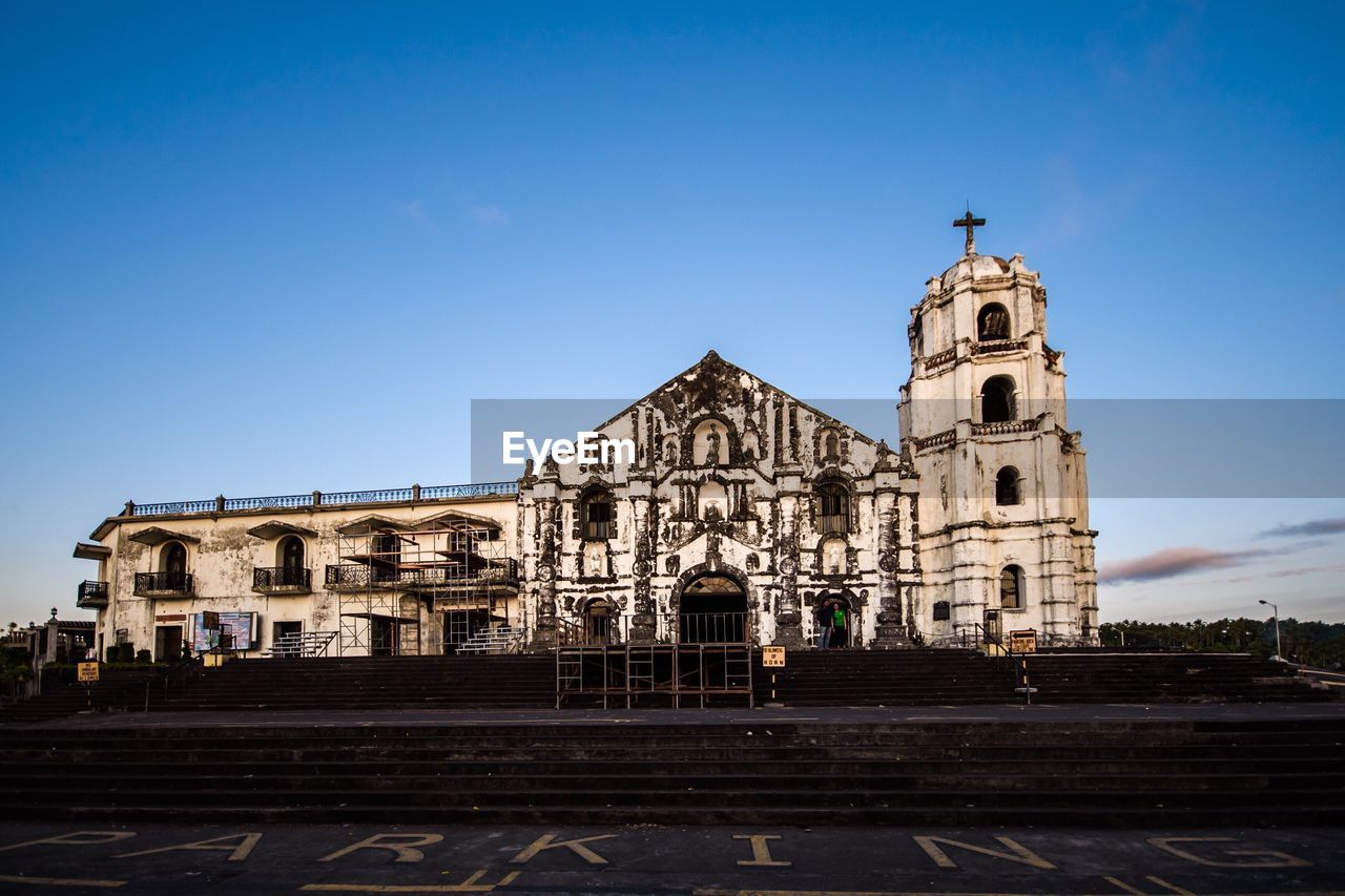 Low angle view of church against clear blue sky