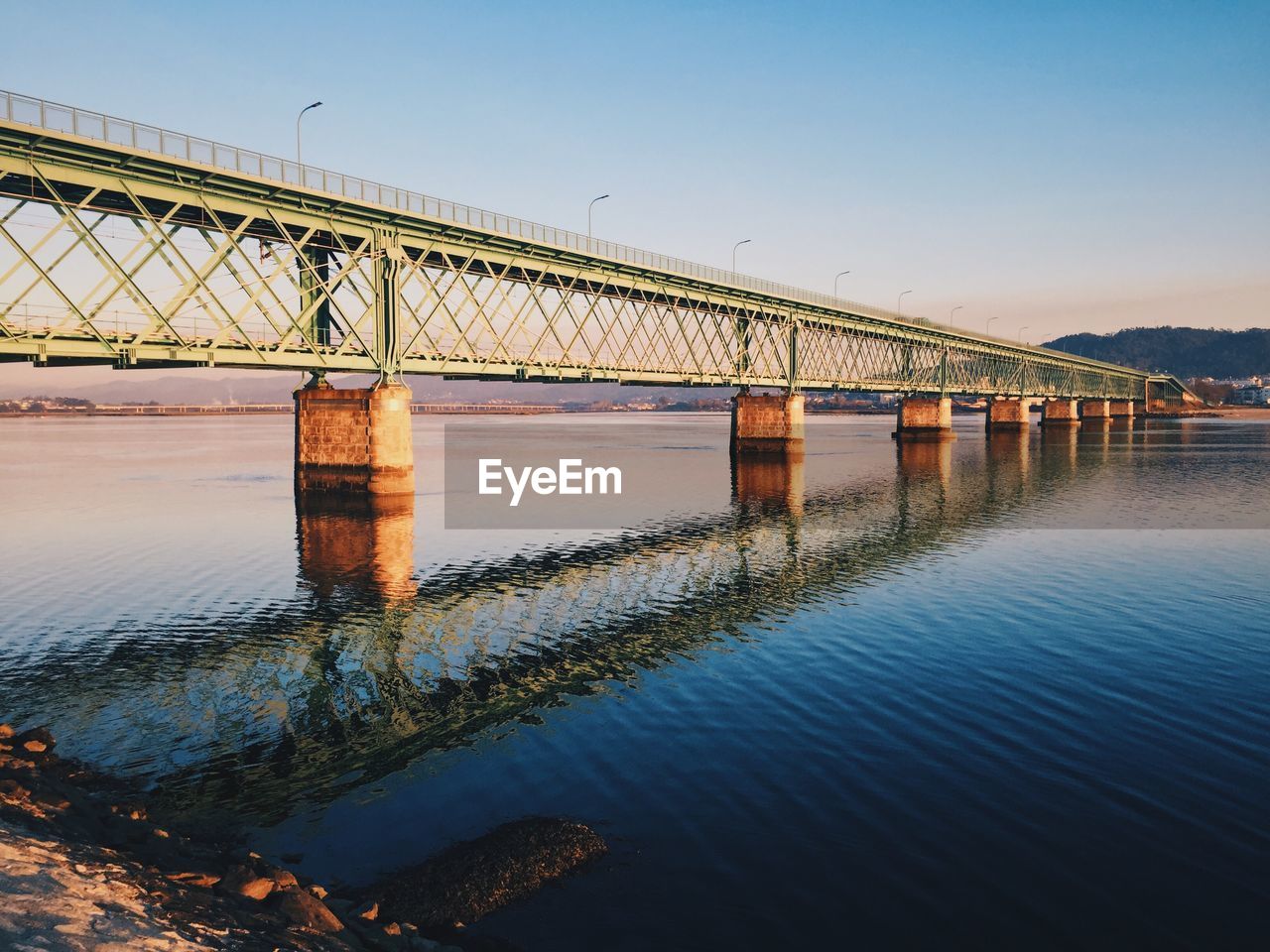 Bridge over river against clear sky