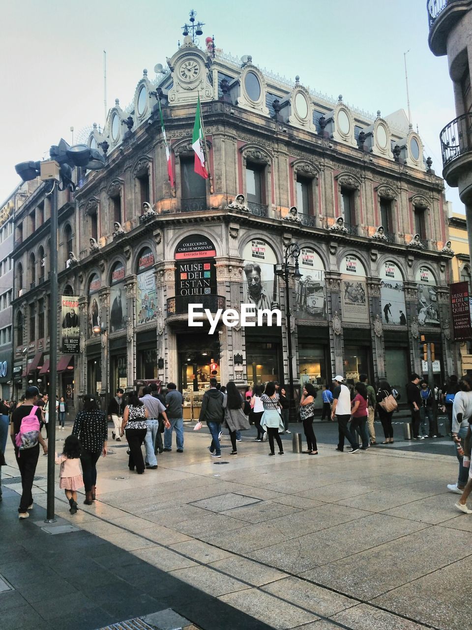 PEOPLE WALKING IN FRONT OF BUILDINGS