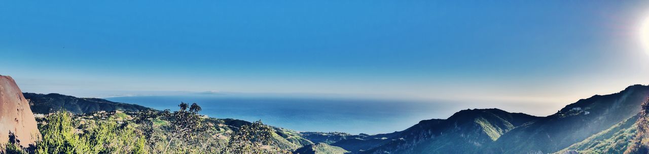 PANORAMIC SHOT OF SEA AND MOUNTAINS AGAINST SKY