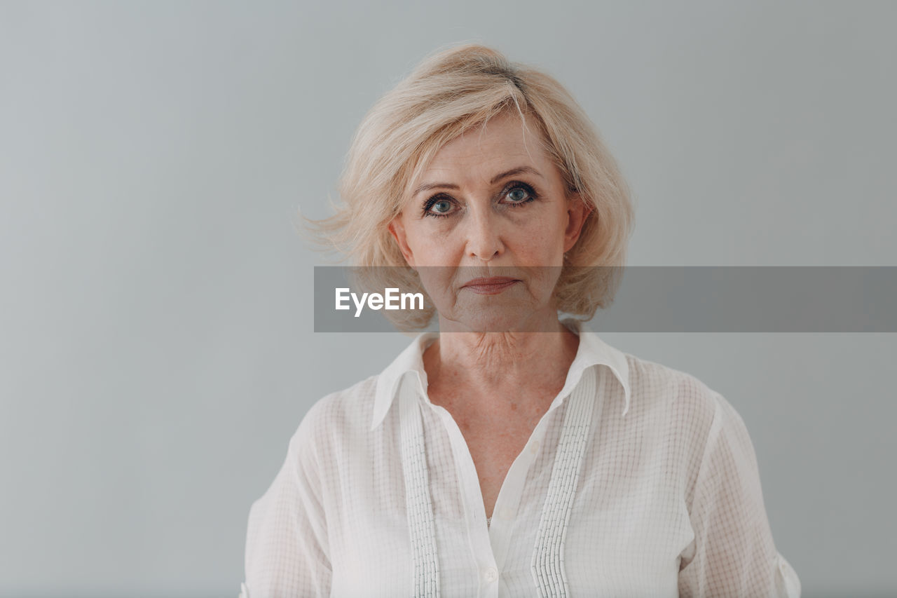 Portrait of woman against white background