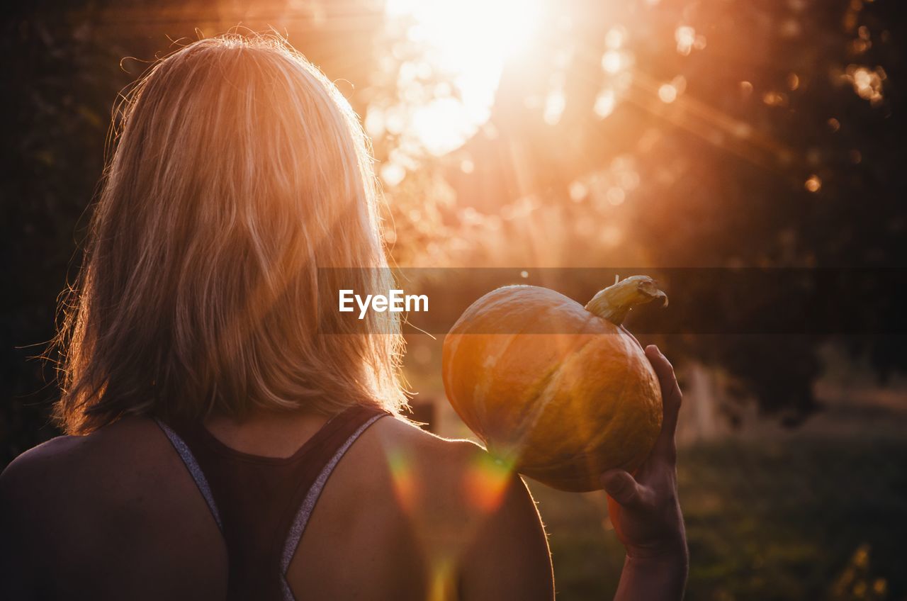 Portrait of woman holding pumpkin