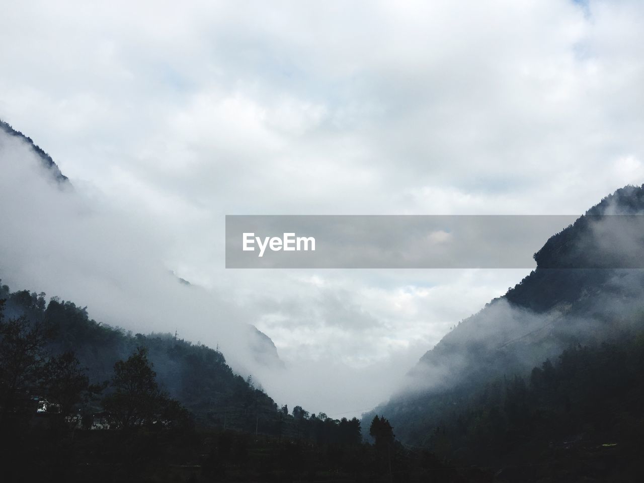 Scenic view of mountains against cloudy sky