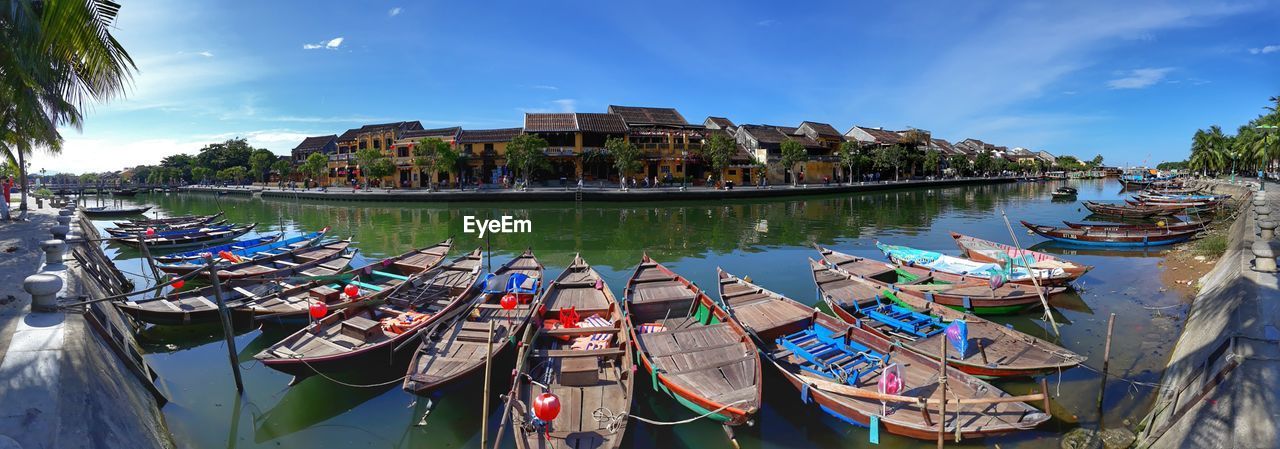 PANORAMIC VIEW OF BOATS MOORED IN RIVER