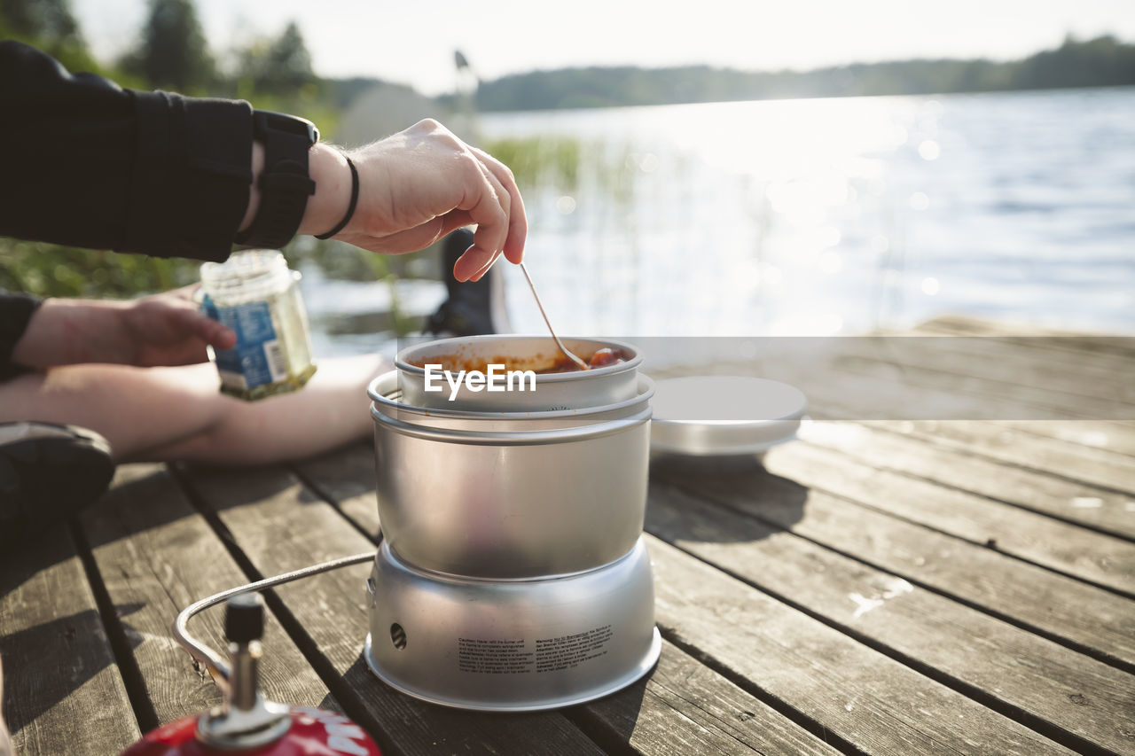 Woman preparing food at lake