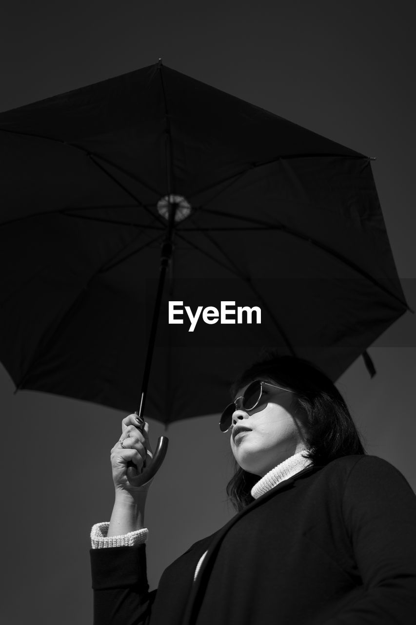 umbrella, protection, security, rain, fashion accessory, wet, black and white, adult, parasol, monochrome, black, one person, holding, shield, shielding, monochrome photography, studio shot, sheltering, women, young adult, storm, monsoon, standing, nature, portrait, looking, rainy season