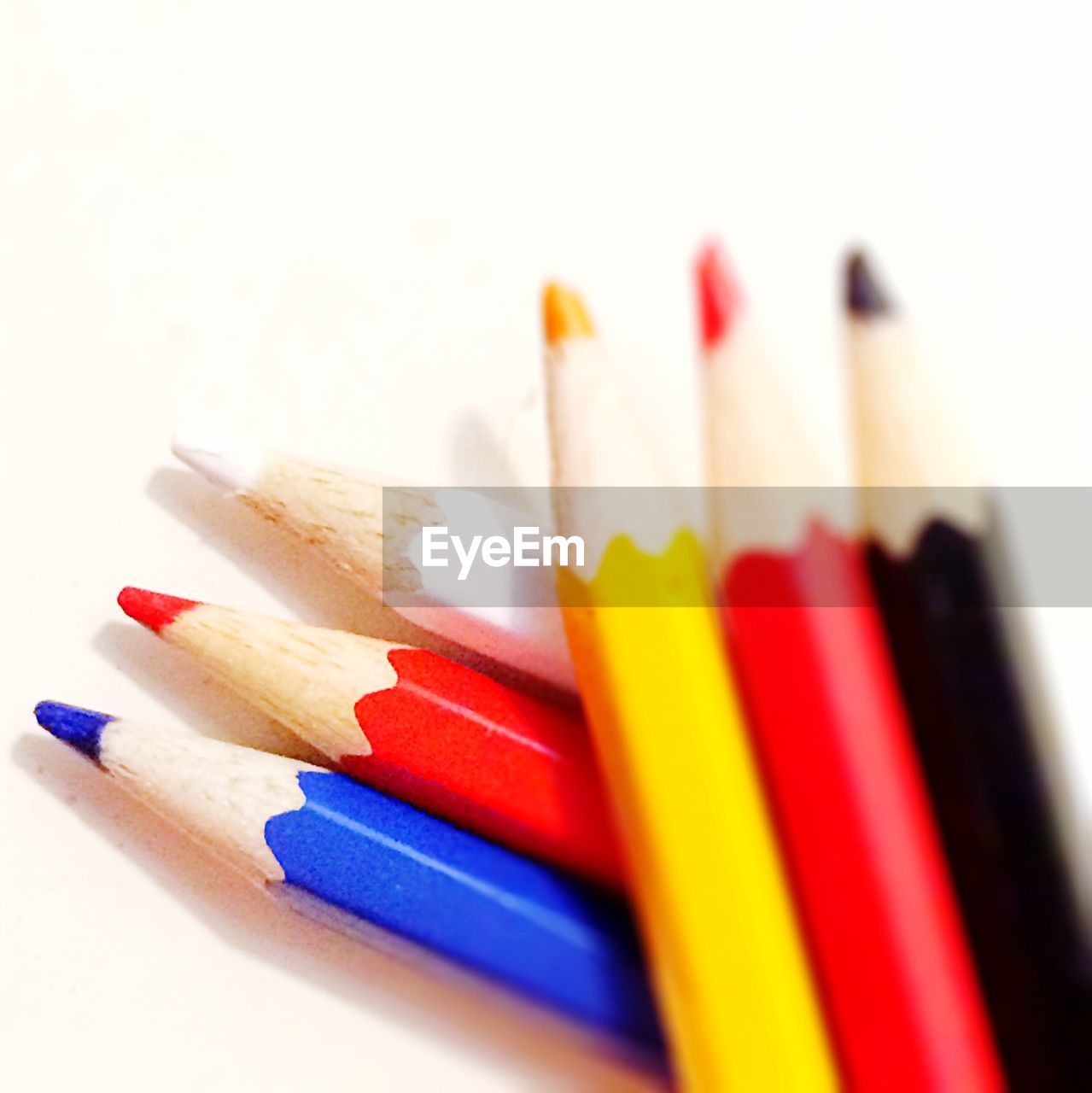 High angle view of multi colored pencils against white background