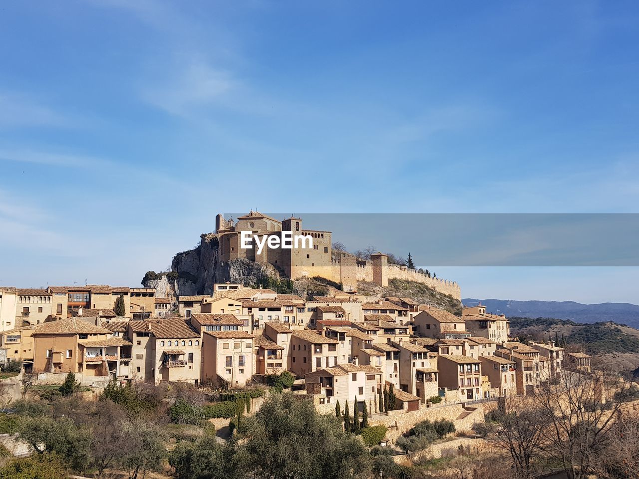 Low angle view of old buildings against blue sky