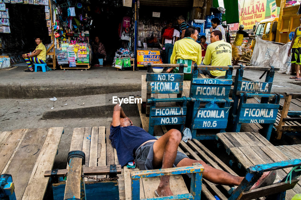 PEOPLE IN MARKET STALL