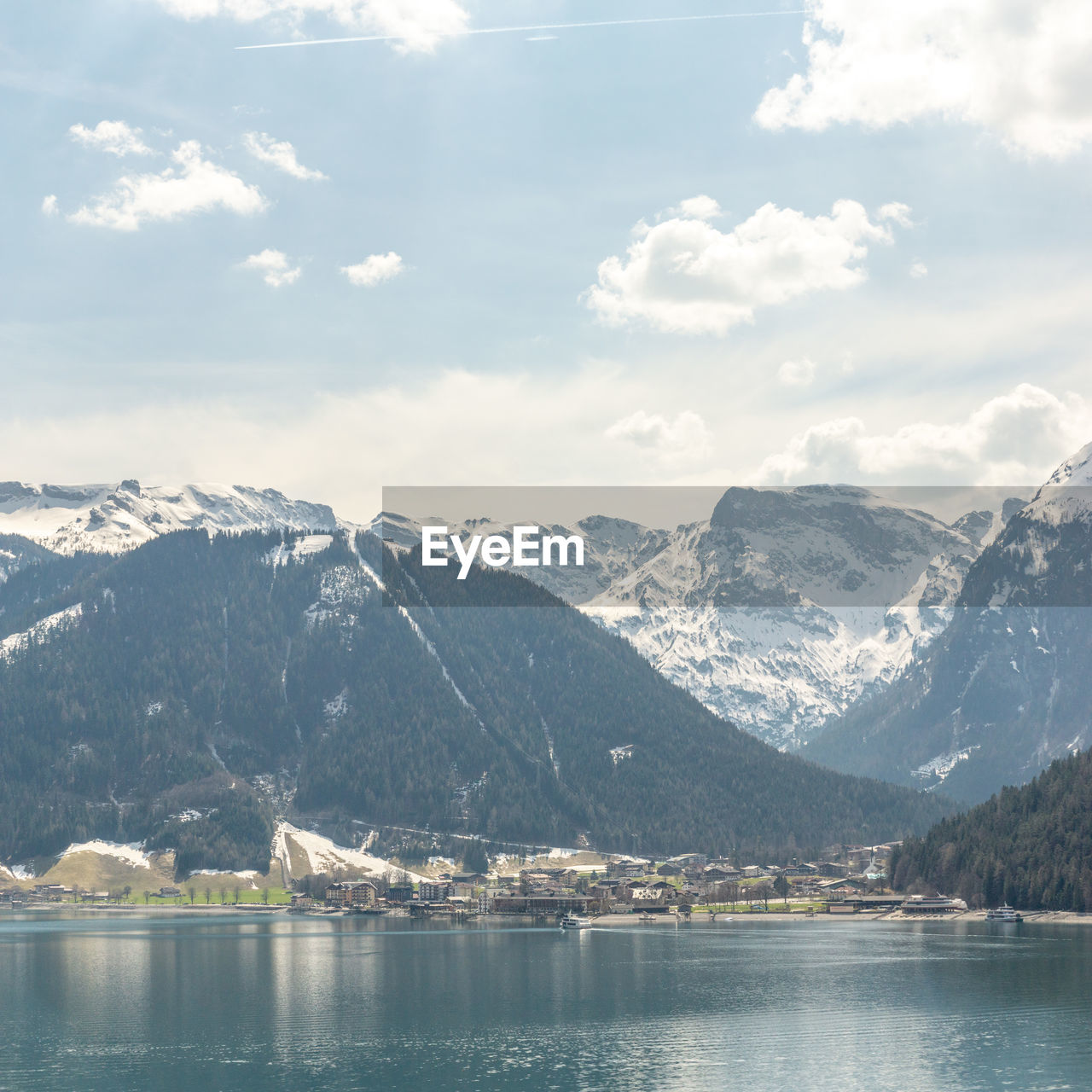 Scenic view of lake and snowcapped mountains against sky