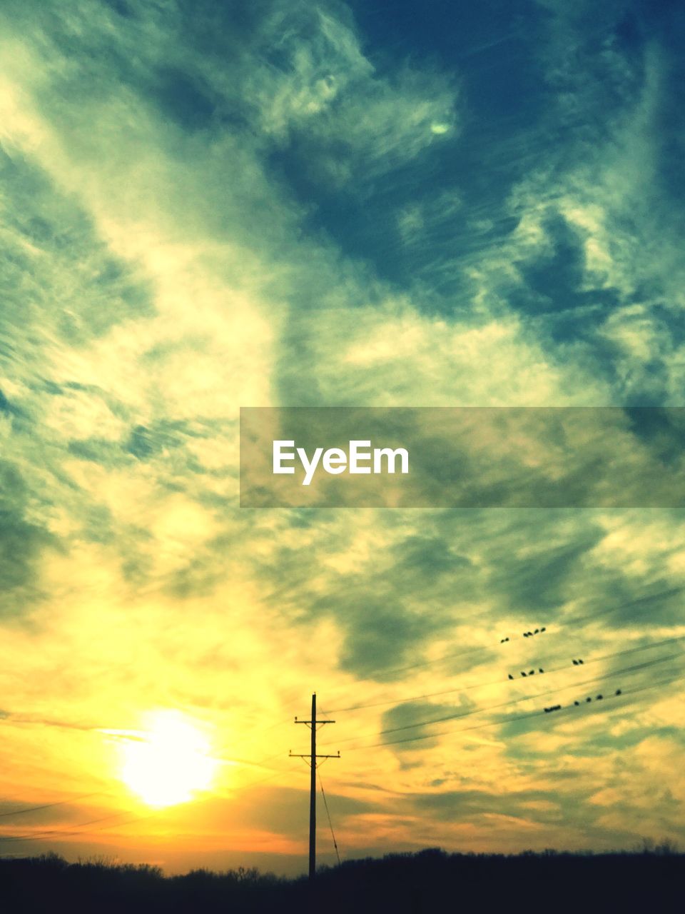 LOW ANGLE VIEW OF SILHOUETTE ELECTRICITY PYLON AGAINST SKY