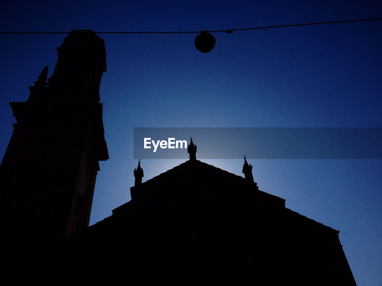 Low angle view of silhouette verona cathedral against clear blue sky