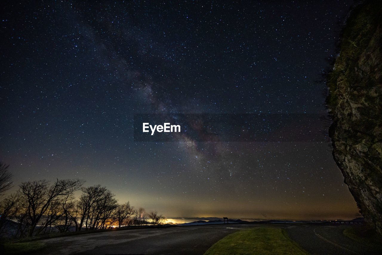 Scenic view of road against sky at night