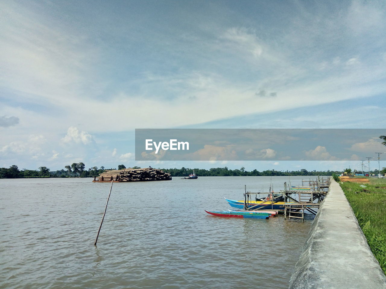 FISHING BOAT MOORED IN SEA AGAINST SKY